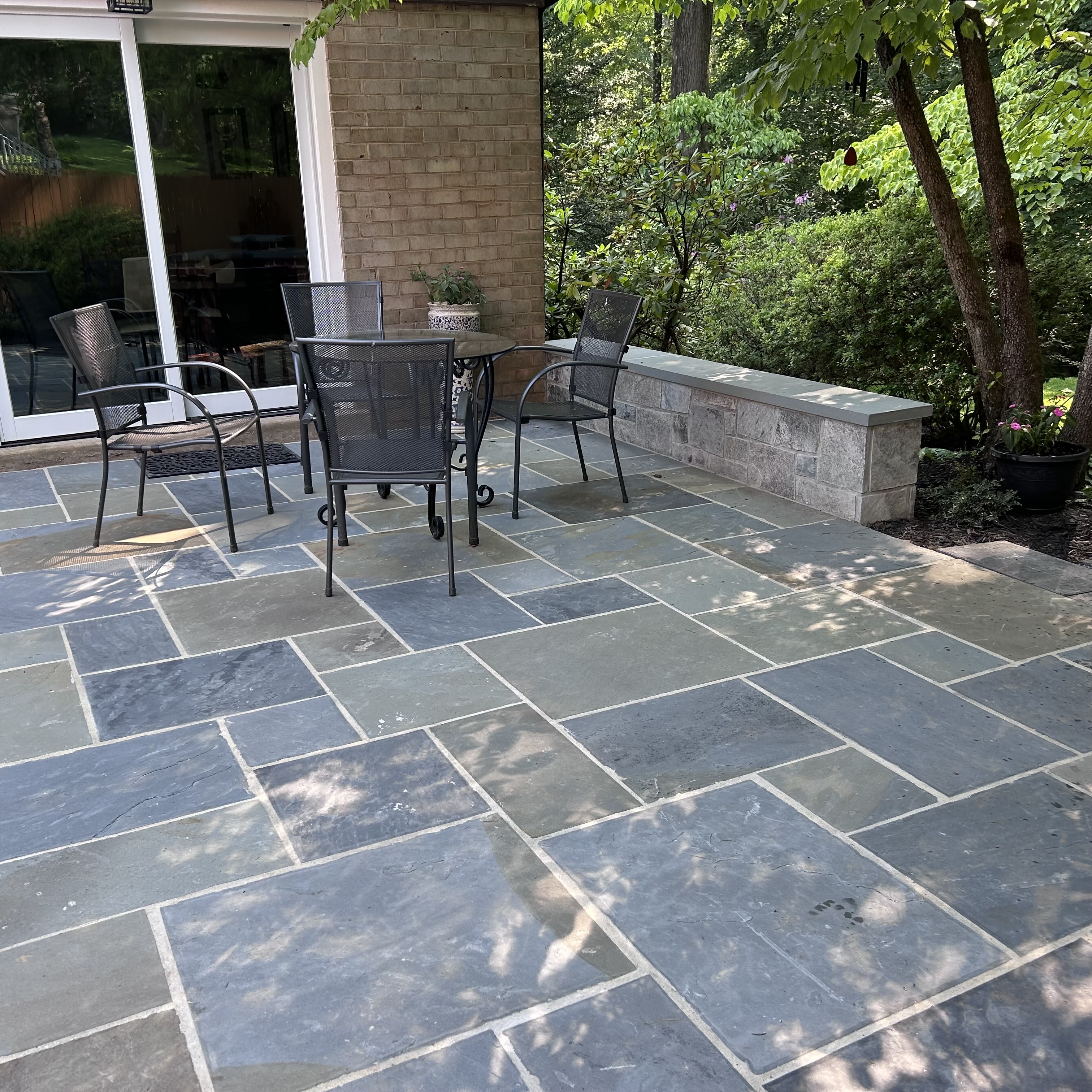 Backyard bluestone patio with seating wall